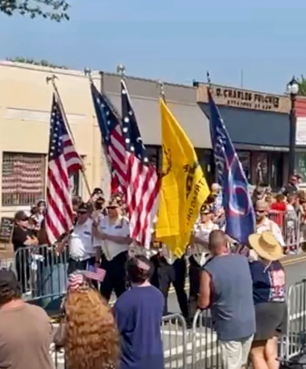 American and veterans organization flags pass spectators in downtown Jasper.