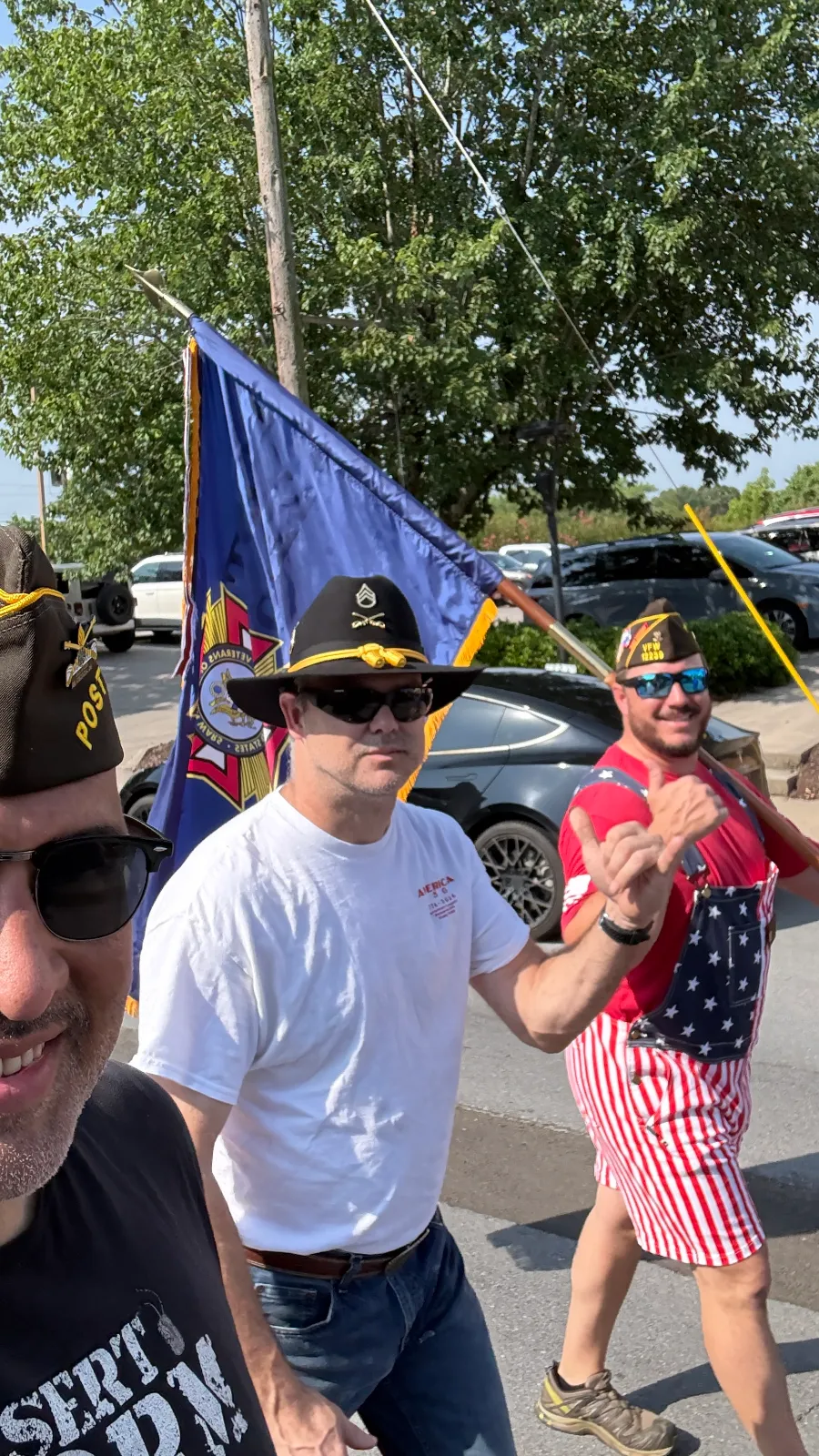 Three VFW members beside the blue VFW flag during the July 4 celebration in Jasper.